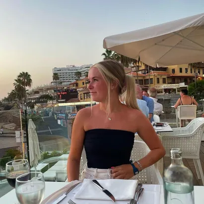 Blonde woman dining at sunset at H10 Gran Tinerfe.